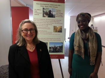 Professor Eileen Doll and student with presentation boards