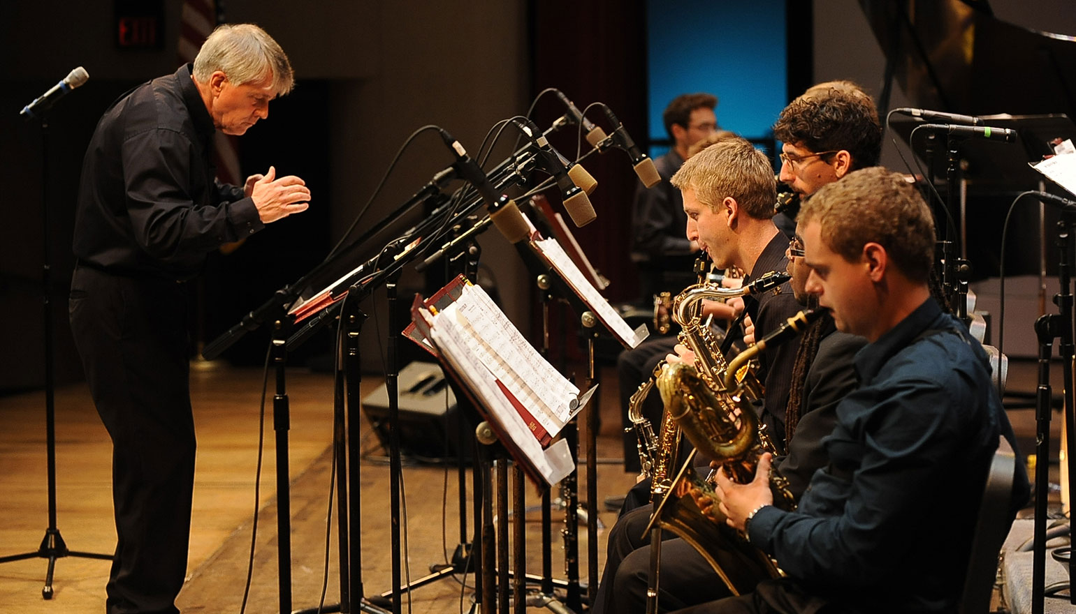 Student jazz band preparing to play wiht conductor