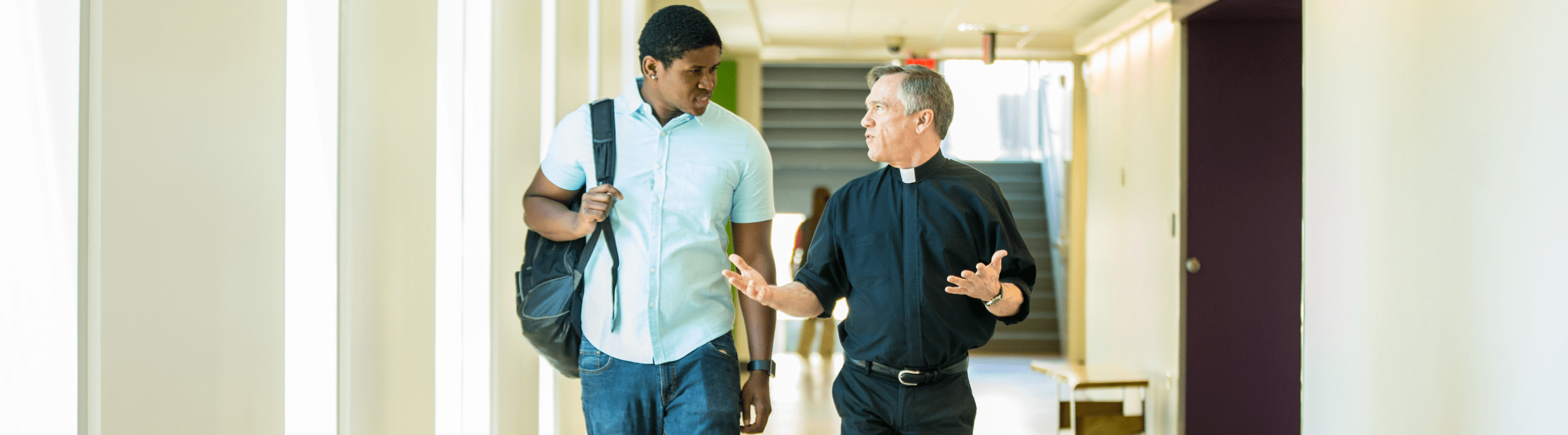 online master of religious studies student speaking with a professor.