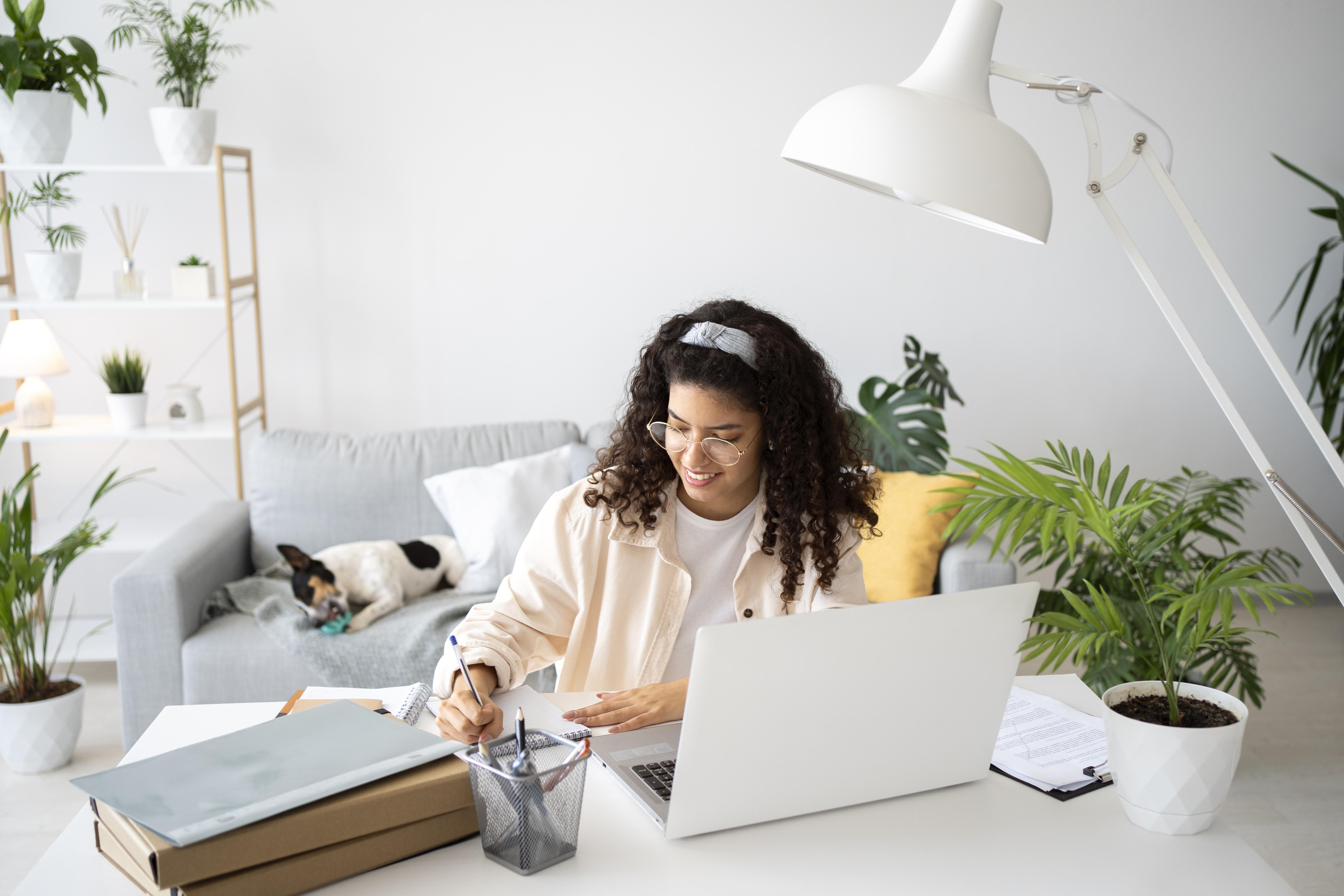 Woman works on her laptop at home